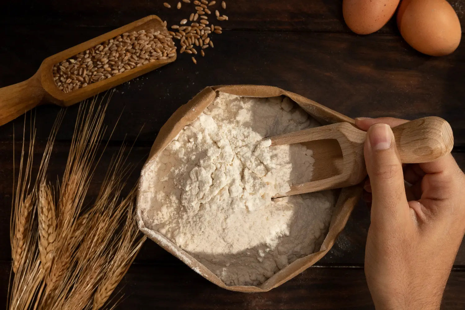 Baker scooping flour from an open foodservice bag