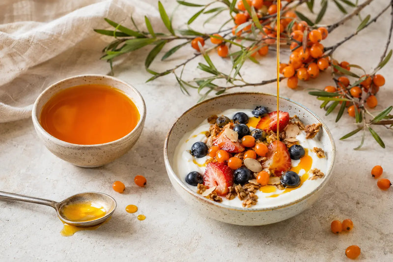 Sea buckthorn oil drizzled over a yoghurt and fruit bowl