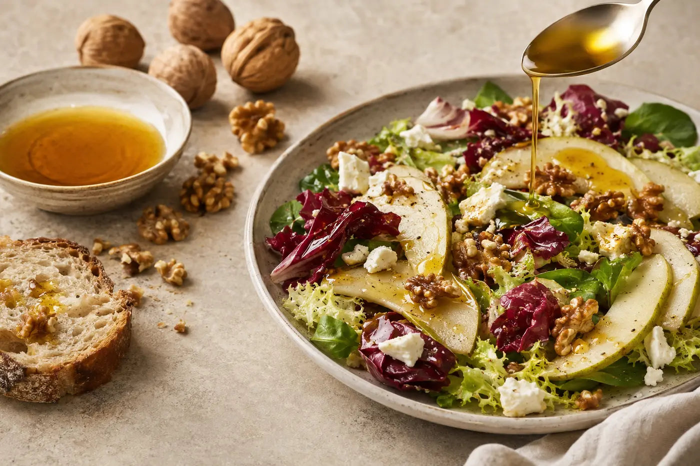 Walnut oil drizzled over pear, walnut and goat cheese salad